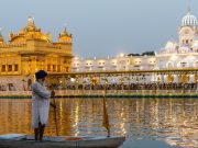 A serene view of the Golden Temple in Amritsar, reflecting its golden dome and sacred pool, symbolizing peace and spirituality for visitors on the Amritsar-Vaishno Devi-Srinagar Tour Package.